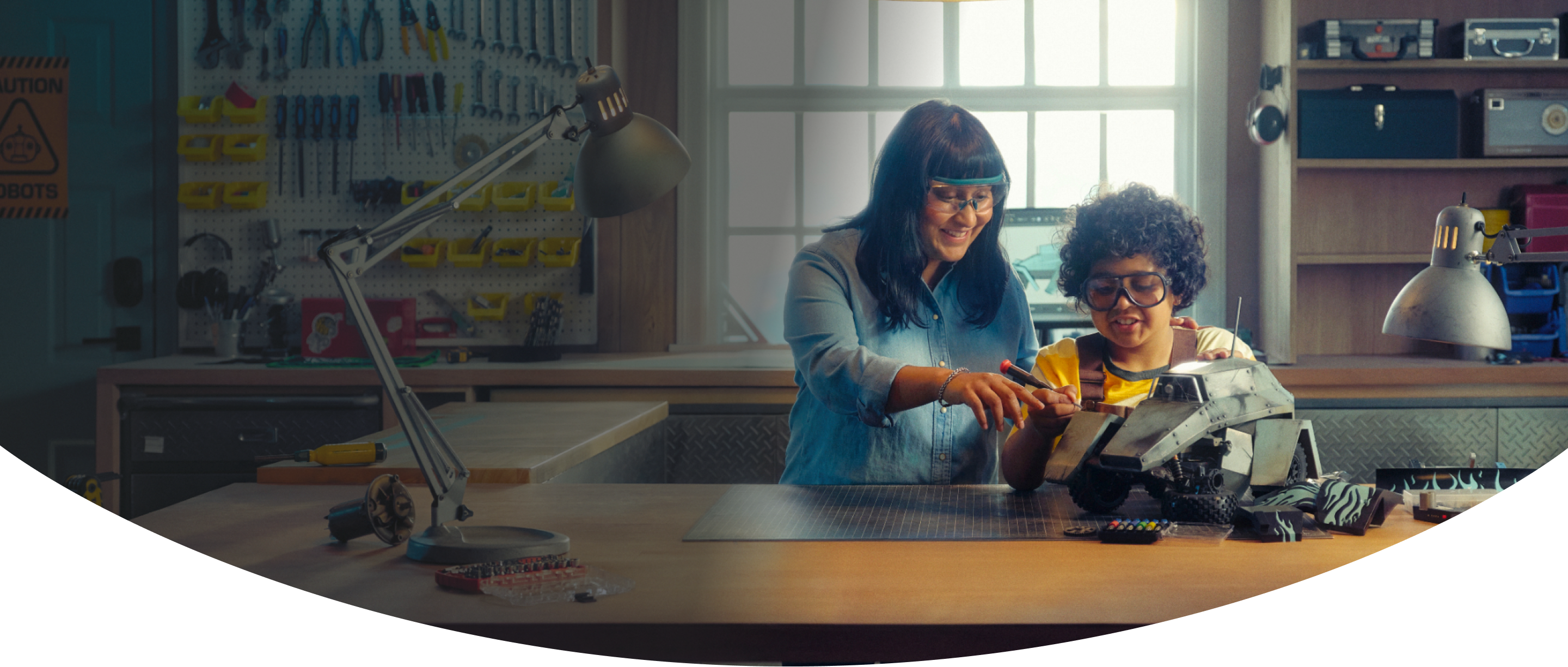 A woman and a young boy working together on a remote-controlled vehicle