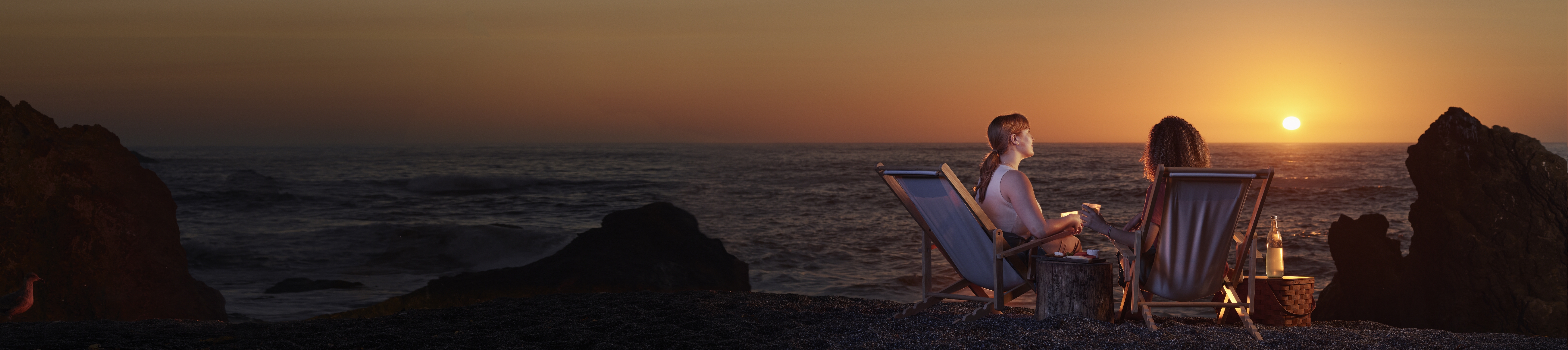 women on the beach at sunset