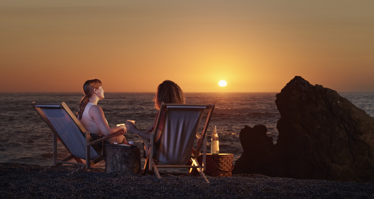 women on the beach at sunset mobile