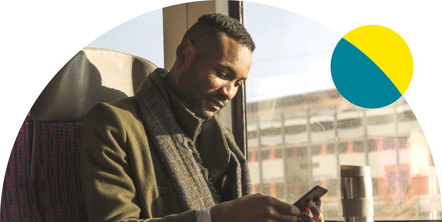 Adult man on the train sitting and looking at his phone