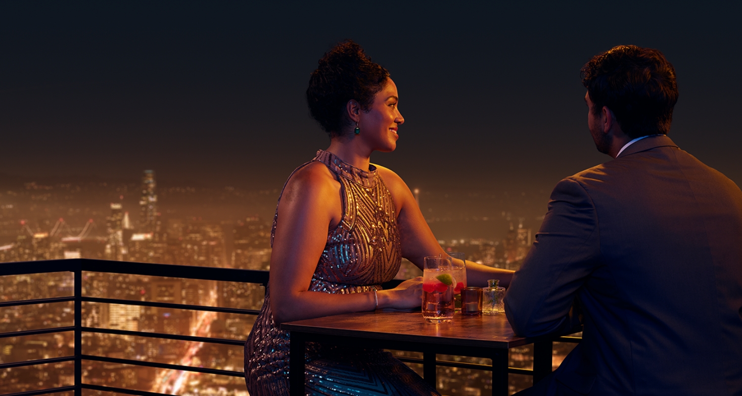Man and woman chatting on a rooftop