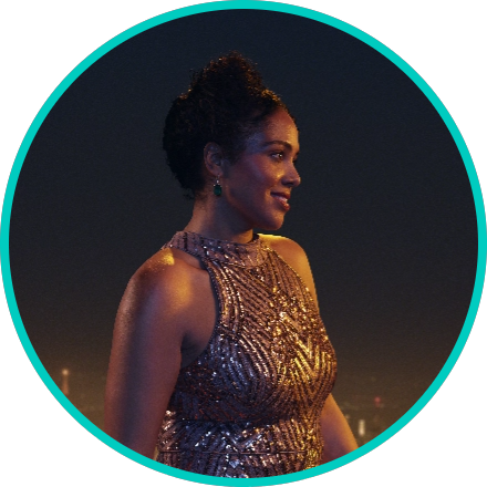 Woman in a sequin dress looking to the right with a night sky in the background