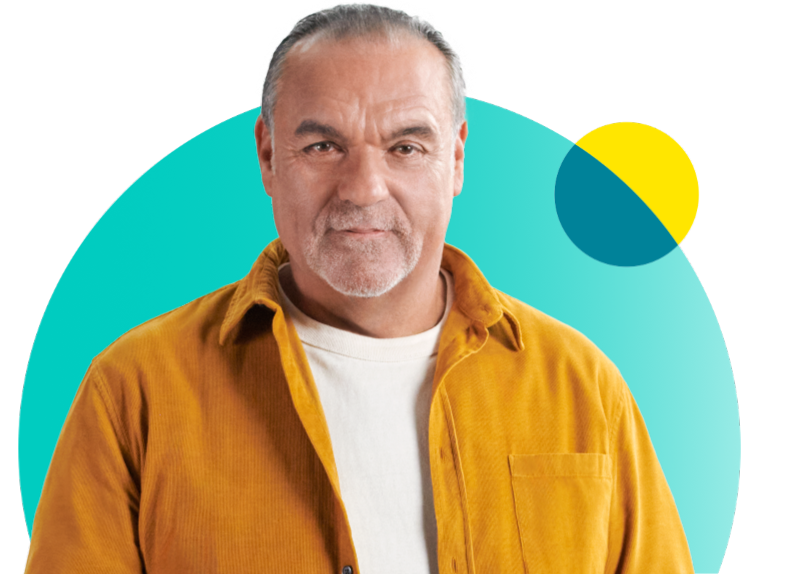 Man in yellow jacket and white shirt staring straight ahead in front of teal and yellow circles