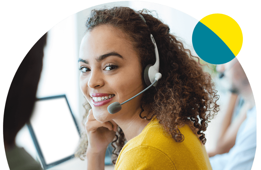 Woman in yellow shirt with headset on and smiling