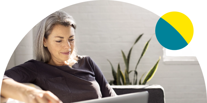 Woman smiling looking down at her laptop