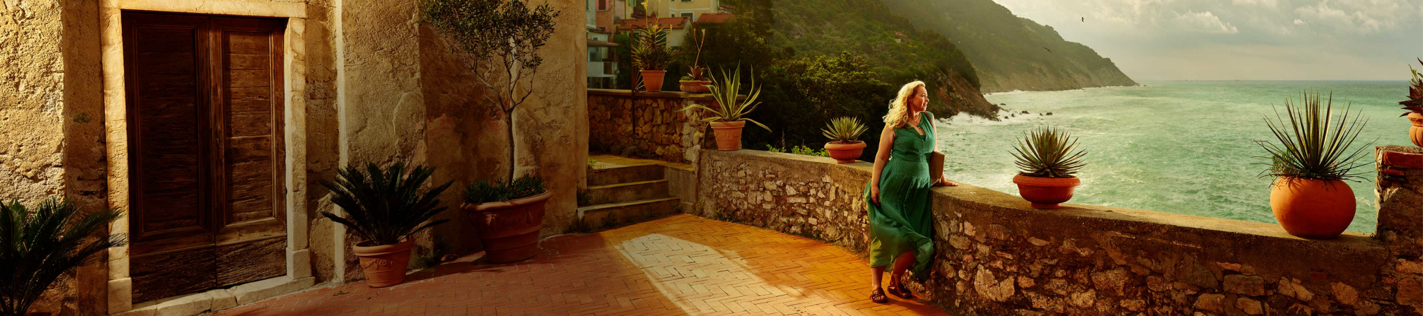 Woman looking out into the distance with water and mountains in the background