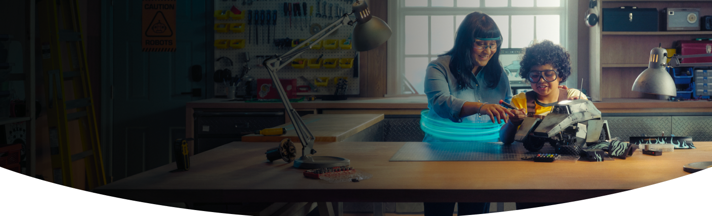 Woman and boy building a robot together in a garage