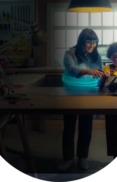 Woman and boy building a robot together in a garage