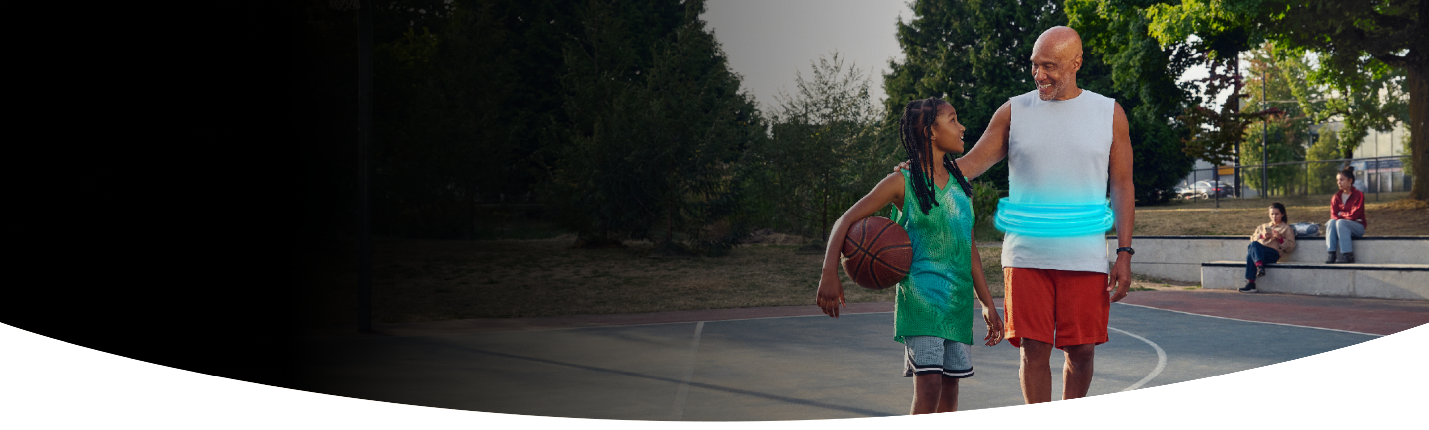 Man and girl standing together on a basketball court