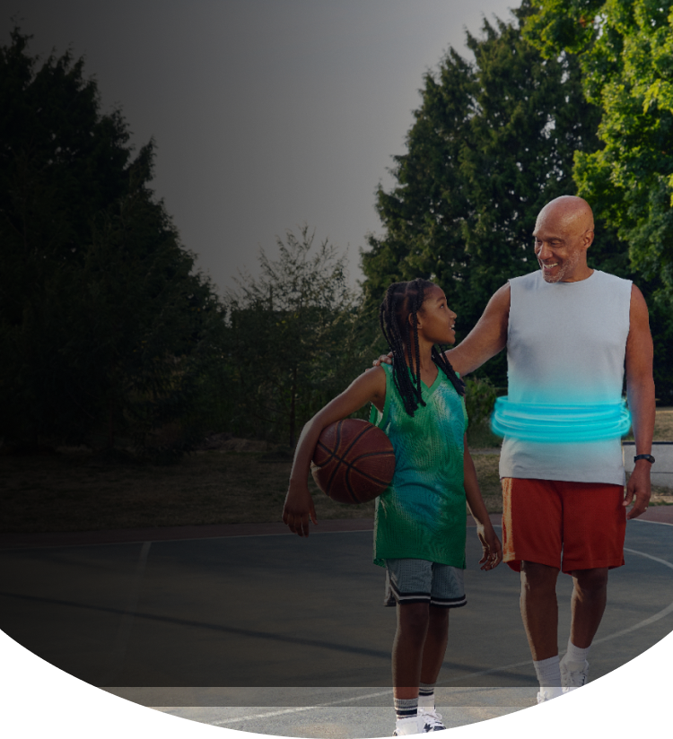 Man and girl standing together on a basketball court
